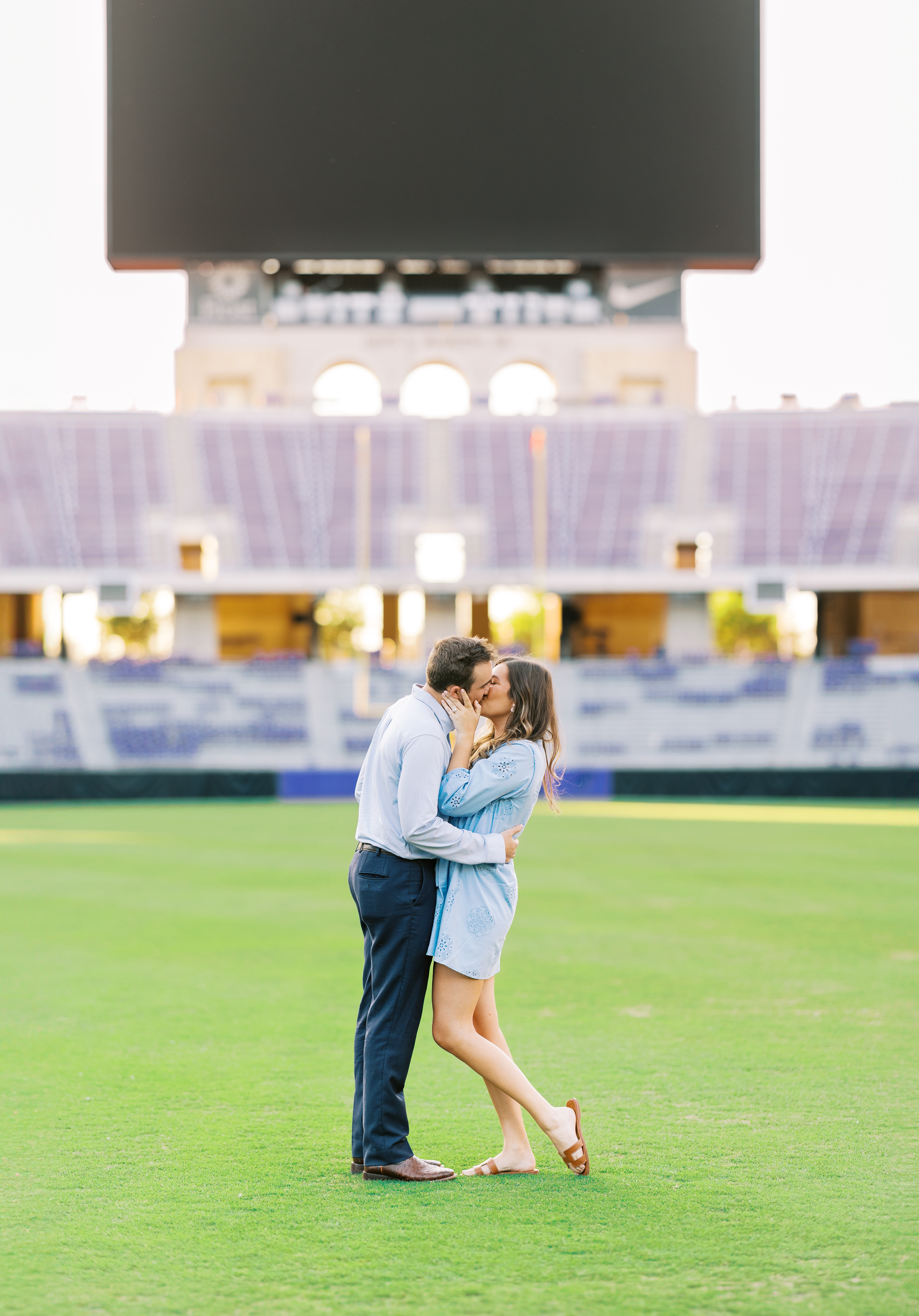 Spencer proposes to Samantha on the TCU football field at sunset, with joyful laughter and surprise captured in the moment.