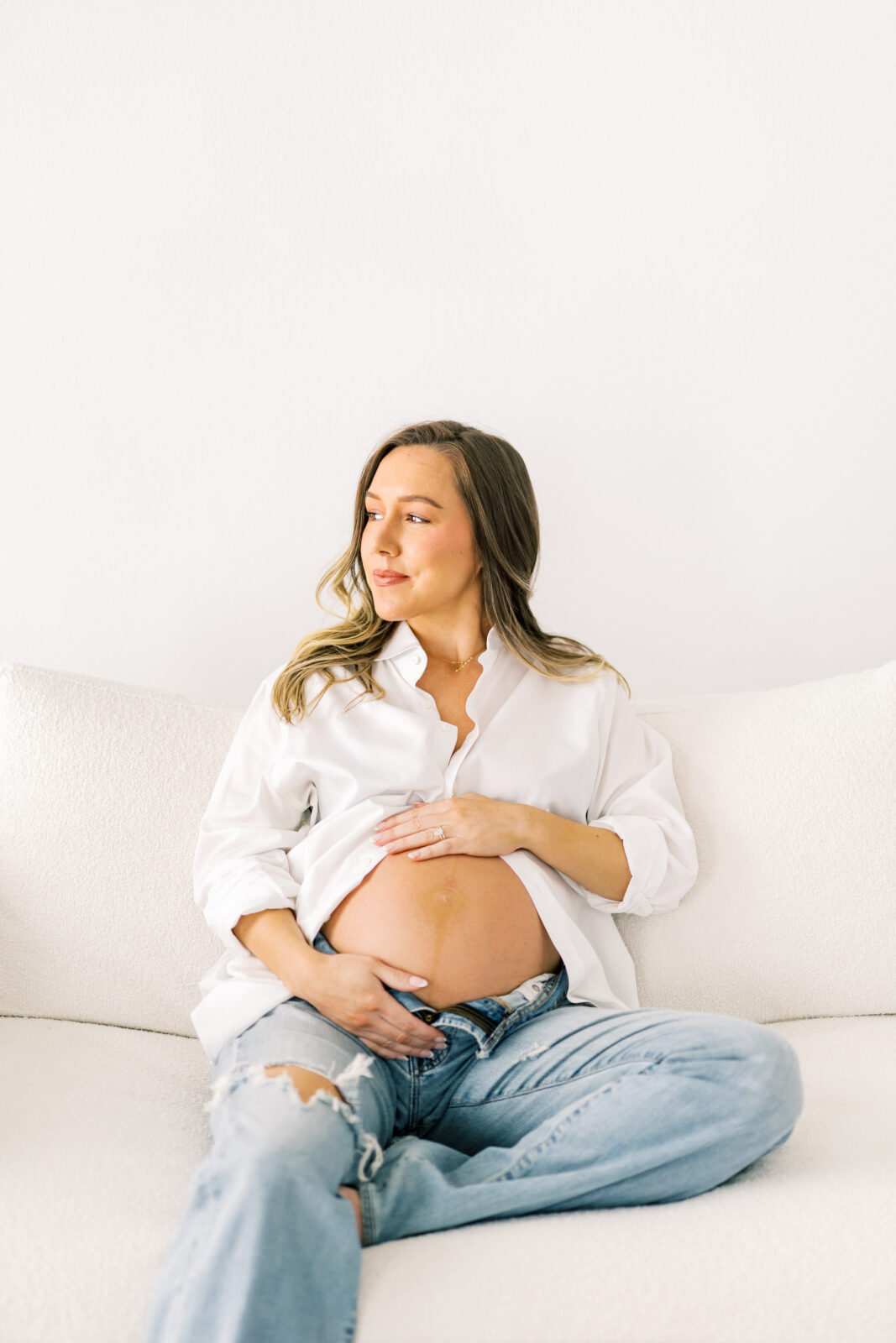 Dallas maternity photographer captures mom-to-be in denim and white button-down outfit