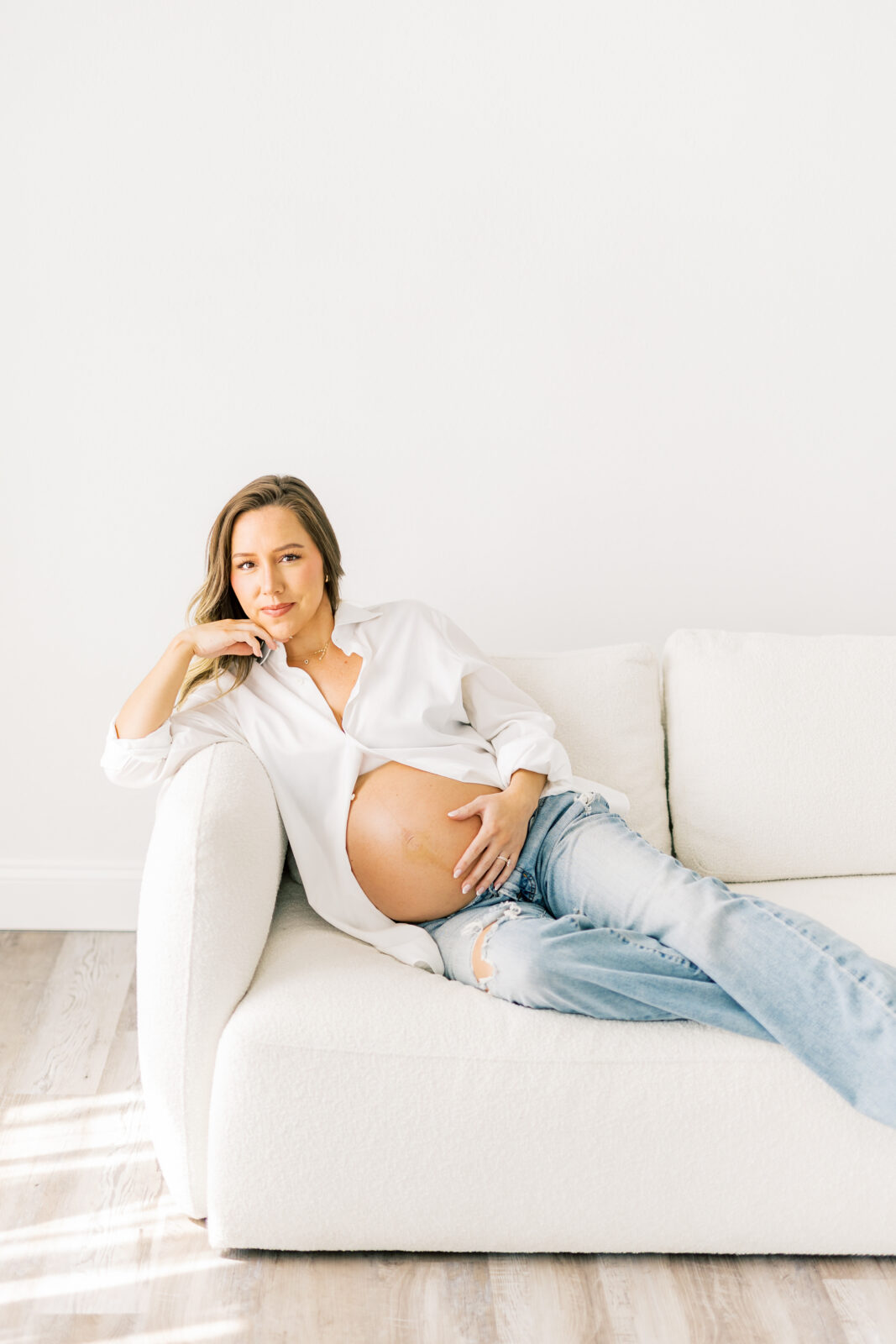 Dallas maternity photographer captures mom-to-be in denim and white button-down outfit