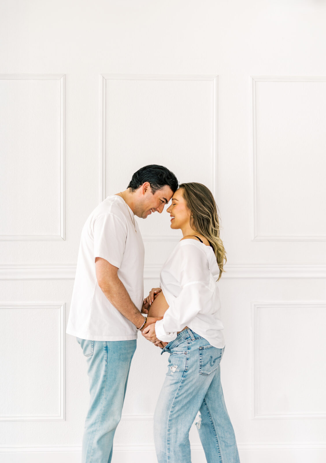 Expecting parents posing together during Dallas maternity photography session in Dallas studio