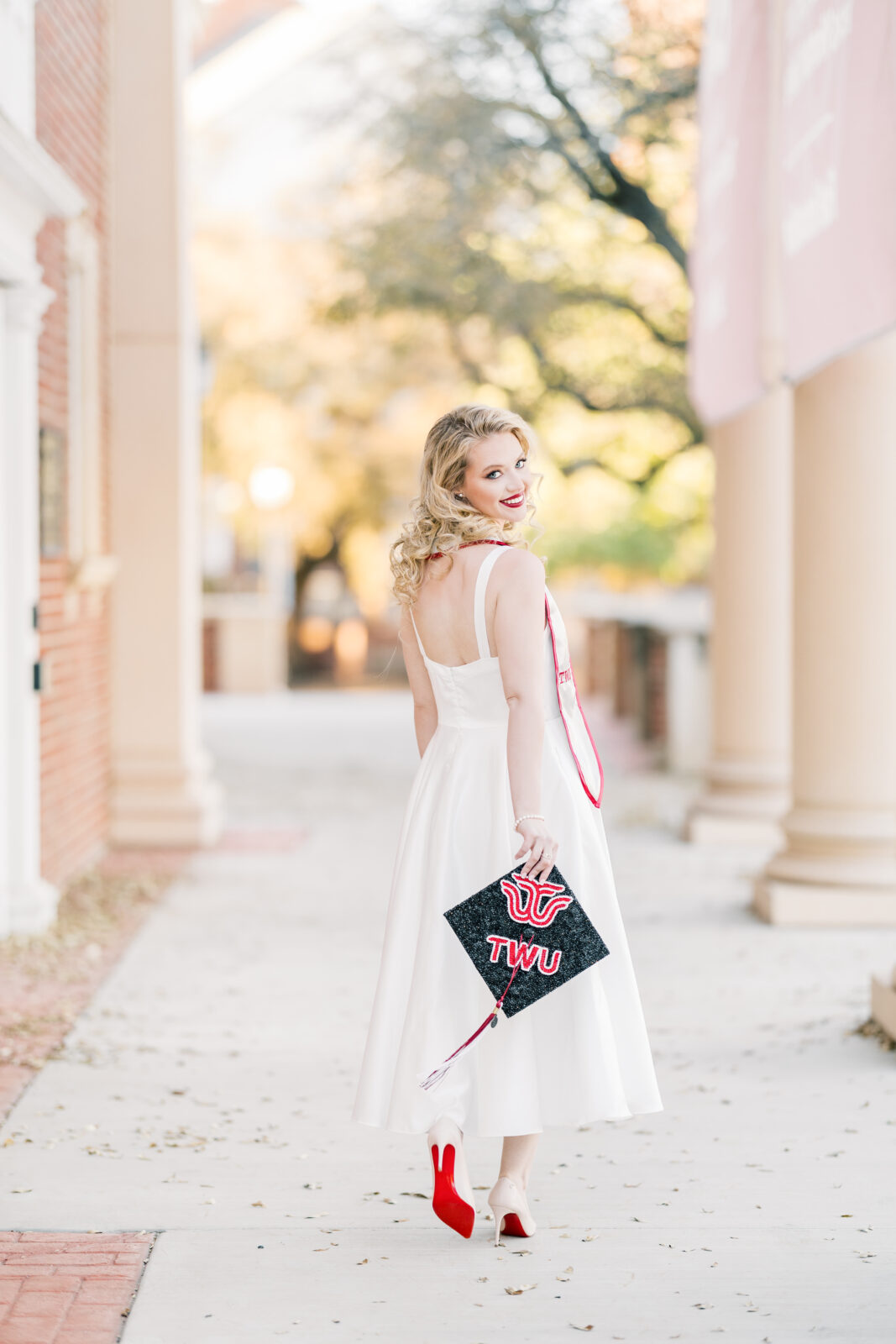 Avery walking in her Louboutins during Texas Woman’s University graduation photos.