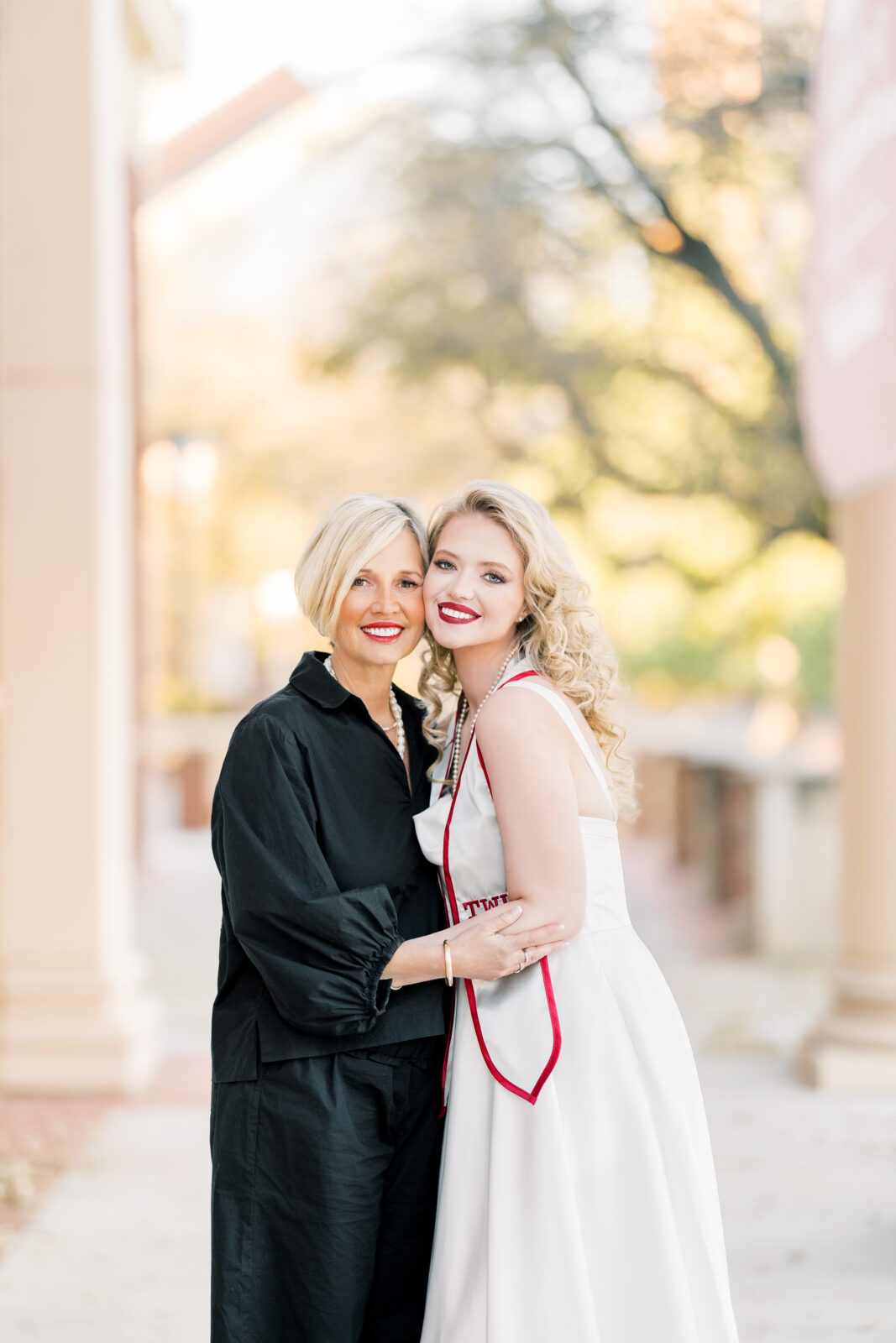 Avery and her mom smiling together during TWU graduation portraits.