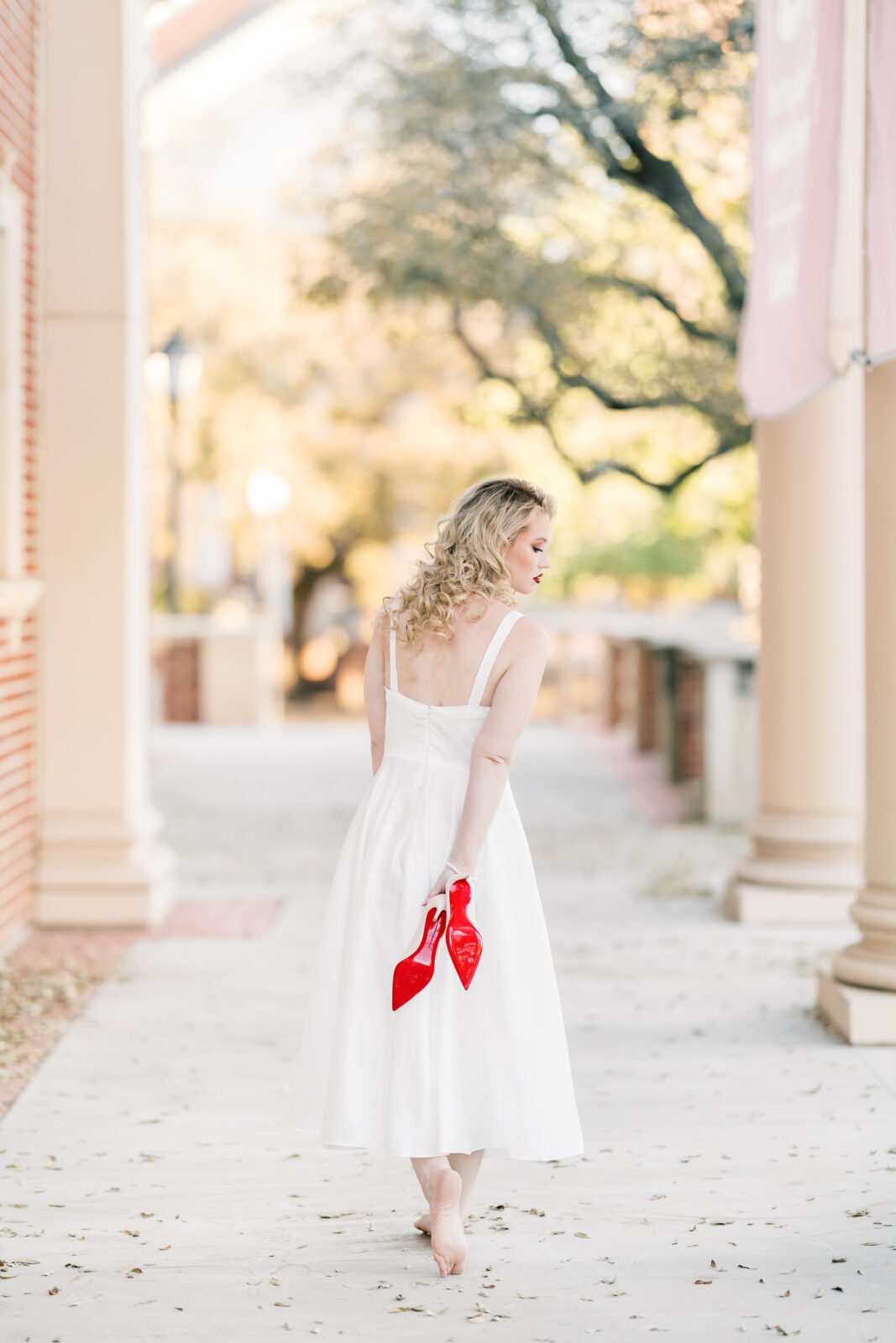 Avery walking in her Louboutins during Texas Woman’s University graduation photos.