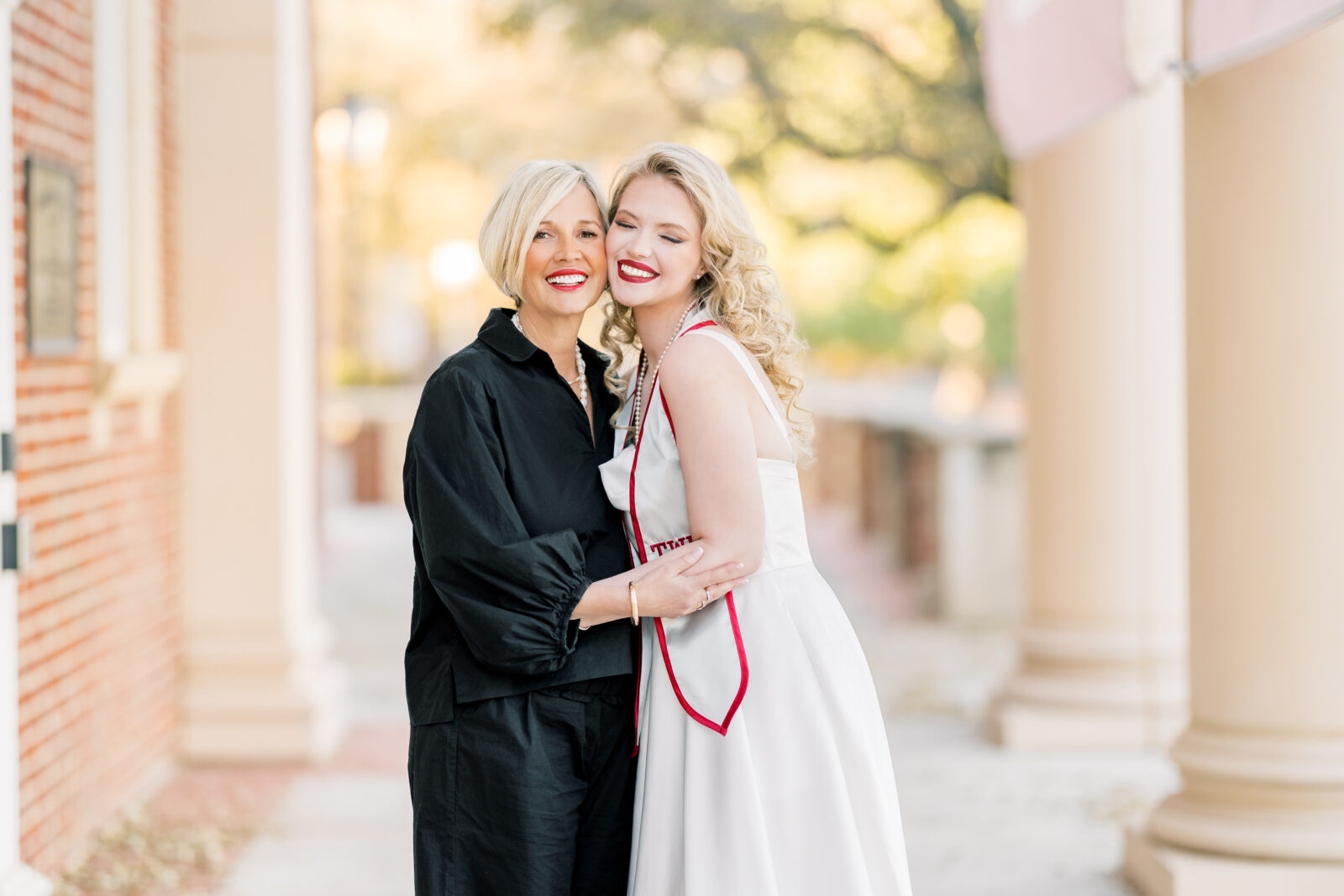 Avery and her mom smiling together during TWU graduation portraits.