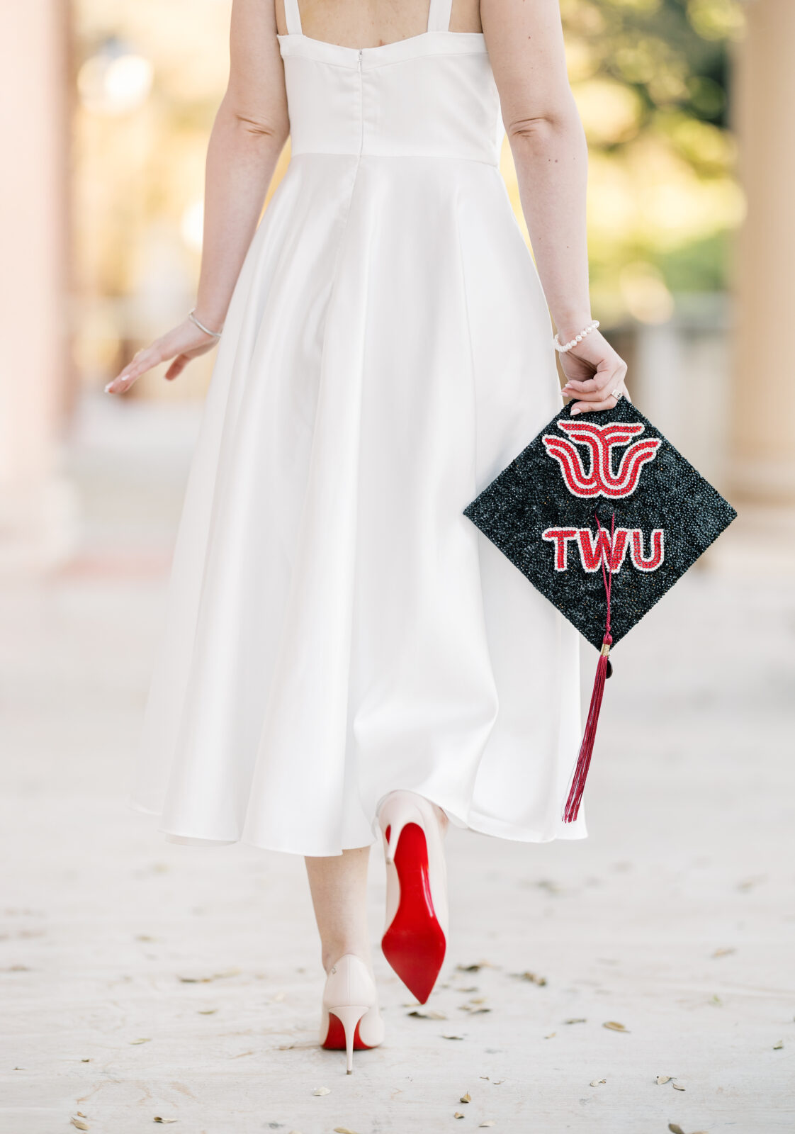 Avery walking in her Louboutins during Texas Woman’s University graduation photos.