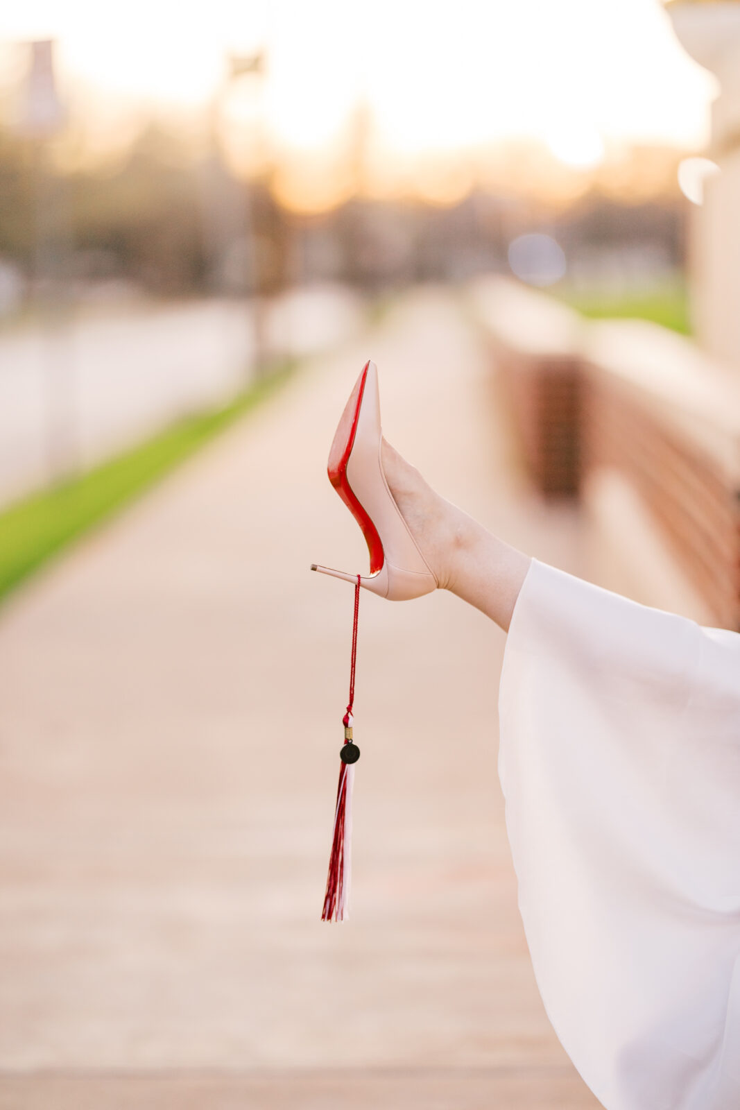 Avery walking in her Louboutins during Texas Woman’s University graduation photos.