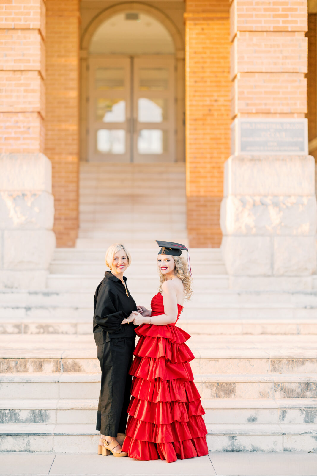 Avery and her mom smiling together during TWU graduation portraits.