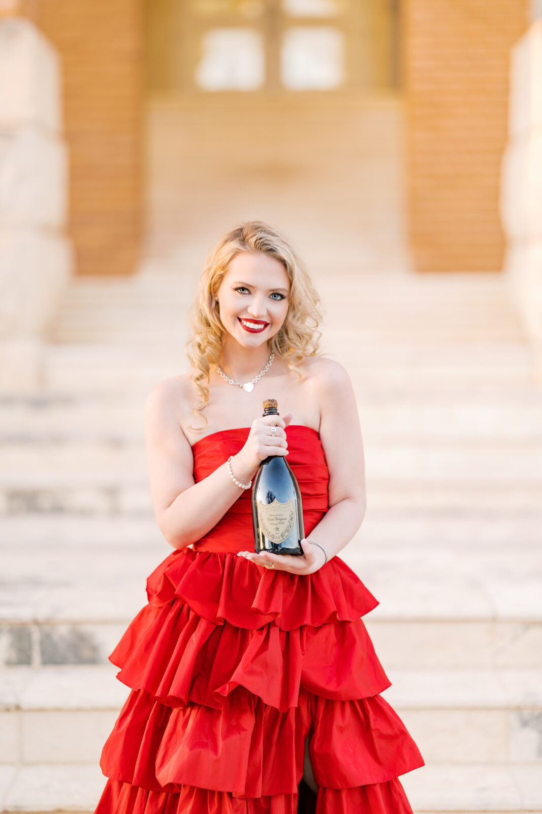 Avery pops a bottle of Dom Pérignon for her TWU graduation portraits.